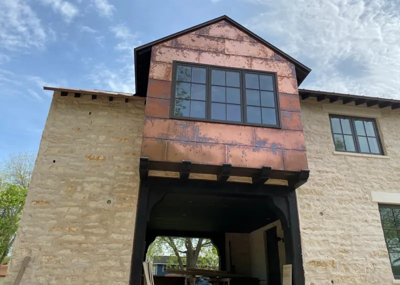 Copper metal panel facade on a stone building for Metal Roof Coating in Nappanee